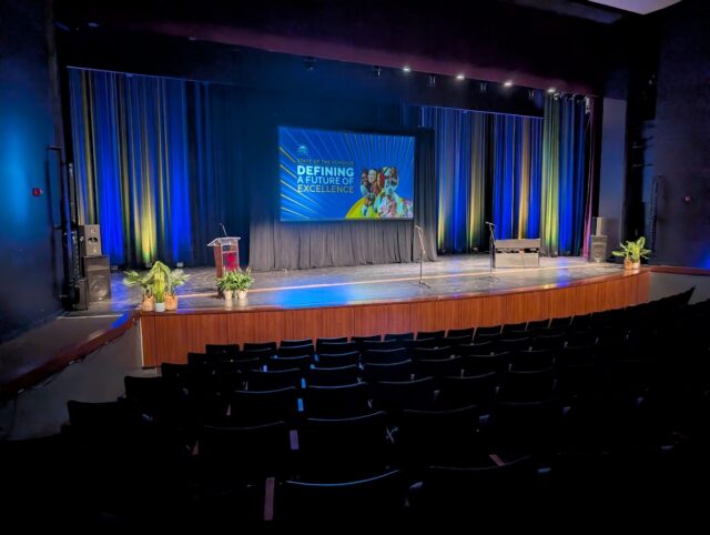 AV live event stage with projector draping and audio equipment