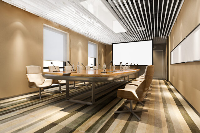 corporate conference room with projector and microphones at each seat