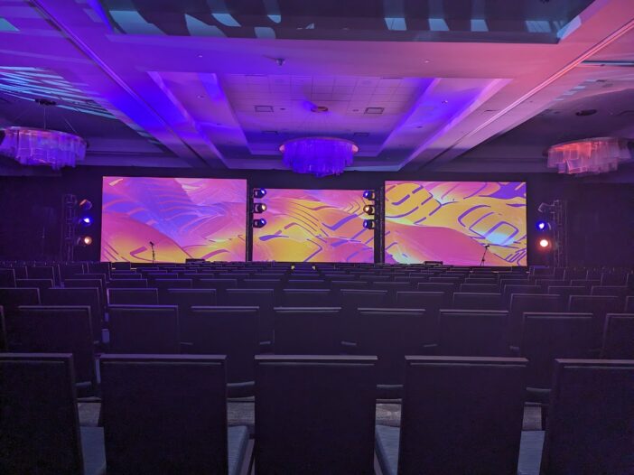 live event AV setup with large LED walls and projections