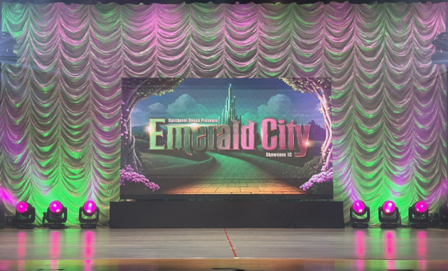 LED wall on stage with pink and green lighting that Mercury Sound & Lighting built & programmed